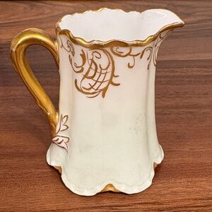 Elegant Gold and White Ceramic Pitcher